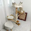 Two cats are playing on a multi-level cat tree with baskets and a plush stool. Produktbild-Vorschau