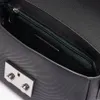 A close-up view of the inside of a black Lacoste handbag, showing the zipper and a metal clasp. Anteprima dell’immagine prodotto