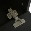 A close-up view of a metal hinge attached to a black surface. Anteprima dell’immagine prodotto