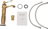 A collection of bathroom faucet parts and a user manual are laid out on a white background. Náhled obrázku produktu
