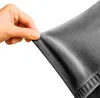A hand is stretching a piece of dark gray fabric, likely a sofa cover, to demonstrate its elasticity. Podgląd zdjęcia produktu