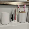 A bathroom sink counter with toiletries. Voir les images du produit
