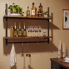 A two-tiered industrial-style wall shelf displaying bottles of alcohol, glassware, and bar accessories. Anteprima dell’immagine prodotto