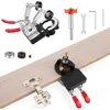 A set of tools for drilling holes for hidden door hinges, laid out on a wooden surface. Produktbild-Vorschau