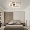 A modern bedroom with a bed, nightstands, and a ceiling light. Voir les images du produit