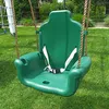 A green child's swing seat with a white safety harness is shown outdoors on a grassy lawn. Náhled obrázku produktu
