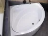 A clean, modern bathroom with a white corner bathtub. Produktbild-Vorschau