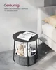 A round side table with a storage basket, placed next to a bed in a bedroom. Produktbild-Vorschau