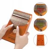 Hands holding a kalimba, with close-up insets showing different colored tines. Produktbild-Vorschau