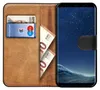 A book-style phone case with a Samsung Galaxy S8 phone inside, along with cards and banknotes. Náhľad obrázku produktu