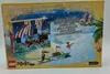 The back of a LEGO Pirates Advent Calendar box, showing a pirate-themed Christmas scene with a ship and beach. Produktbild-Vorschau