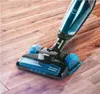 A cordless vacuum cleaner is being used on a wooden floor. Náhľad obrázku produktu