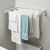 A wall-mounted retractable clothes drying rack with towels hanging on it, in a bathroom setting. Anteprima dell’immagine prodotto