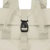 A close-up view of a cream-colored backpack's buckle and straps. Produktbild-Vorschau