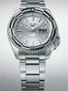 A close-up studio shot of a silver Seiko 5 Sports automatic watch with a black and white bezel. Voir les images du produit