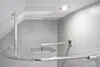 A modern bathroom with grey tiled walls and a white ceiling, featuring a chrome shower curtain rod and a square shower head. Produktbild-Vorschau