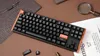 A mechanical keyboard is shown on a brown surface, with some tools and a magnifying glass in the background. Podgląd zdjęcia produktu