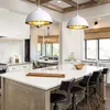 A modern kitchen with a large island, pendant lights, and dining area. Produktbild-Vorschau