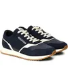 A pair of navy blue Tommy Hilfiger sneakers with white accents and laces, shown from a side angle on a white background. Náhled obrázku produktu