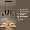 A modern dining room with a pendant light fixture over a table set for a meal. Náhled obrázku produktu