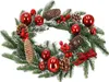 A Christmas wreath decorated with pine cones, red berries, and red baubles, set against a white background. Náhľad obrázku produktu