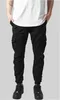 A person wearing black cargo jogging pants and white t-shirt. Anteprima dell’immagine prodotto