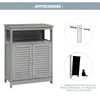 An instructional image showing a bathroom cabinet and how to secure it to the wall to prevent tipping. Podgląd zdjęcia produktu
