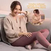 A woman is sitting on a couch, smiling and looking at the camera, while a smaller inset image shows another woman hugging herself. Produktbild-Vorschau