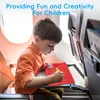 A young boy is drawing on a magnetic drawing board while sitting on an airplane. Produktbild-Vorschau