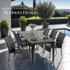 An outdoor dining set with chairs and a table next to a swimming pool. Produktbild-Vorschau