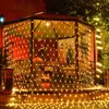 A gazebo decorated with string lights at night. Produktbild-Vorschau