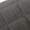 A close-up view of a quilted, gray fabric. Produktbild-Vorschau