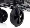 A close-up view of the wheels and frame of a black wagon. Produktbild-Vorschau