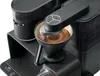 A close-up view of a black coffee maker brewing coffee. Produktbild-Vorschau