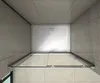 A top-down view of a shower enclosure with the door open, showing the shower tray and tiled walls. Produktbild-Vorschau