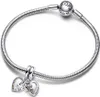 A silver Pandora bracelet with two heart-shaped charms. One charm is split into two halves, with one half showing rainbow-colored stones and the text "True Friends". The other half of the charm is plain silver with the text "True Friends". The second charm Anteprima dell’immagine prodotto