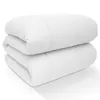A white duvet is folded and stacked on a white surface. Produktbild-Vorschau