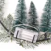 Close-up of a decorative ring with miniature Christmas trees and a battery pack for lights. Anteprima dell’immagine prodotto