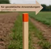 A wooden stake with an orange tip stands in a field, with a directional arrow overlay indicating 'geodetic use'. Produktbild-Vorschau
