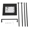 All parts of a black clothing rack are laid out on a white background. The parts include a square base with instructions on it, four vertical poles, and a horizontal support bar. There are also some screws and an Allen wrench. Produktbild-Vorschau
