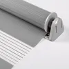 A close-up view of a grey roller blind mechanism and fabric. Produktbild-Vorschau