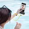 A person is taking a selfie in a swimming pool with a waterproof phone case. Anteprima dell’immagine prodotto