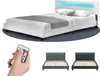 A collage featuring a white LED bed with pillows and a gray blanket in the top portion, and a hand holding a remote control along with two different colored bed frames below. Náhled obrázku produktu