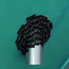 A roll of black tape with white text is wrapped around a silver pipe, set against a teal background. Produktbild-Vorschau
