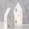 Two white house-shaped lanterns with gold lettering and window cutouts are displayed against a textured gray and white background. Produktbild-Vorschau