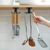 Kitchen utensils hanging from a rack under a shelf. Produktbild-Vorschau