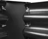 A close-up view of two corrugated metal panels joined together with bolts and wing nuts. Produktbild-Vorschau