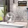 A large floor fan is shown in a room with a textured brick wall and a cactus plant. Podgląd zdjęcia produktu