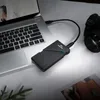 An external SSD is connected to a laptop, with a camera nearby, suggesting a workflow for photographers or videographers. Voir les images du produit