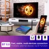A living room scene with a TV, a smart player, a coffee table, and a hand holding a smartphone. Podgląd zdjęcia produktu